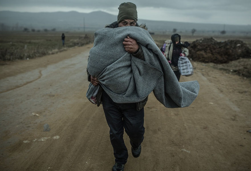 혹독한 추위와 빗속을 뚫고 세르비아 마케도니아의 국경을 넘고 있는 Khaled와 아내, 자녀들.